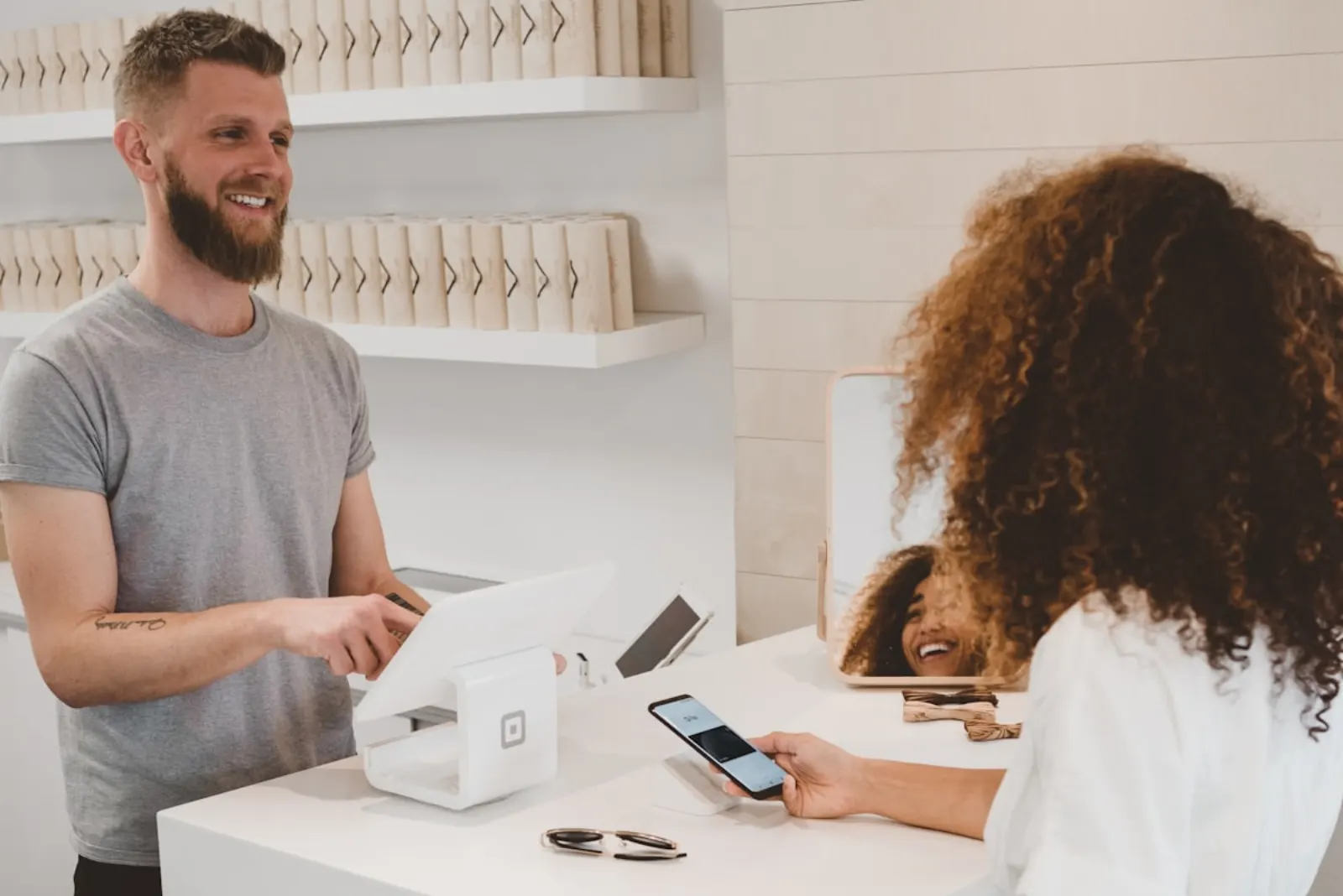 A small-business owner taking a card payment from a customer