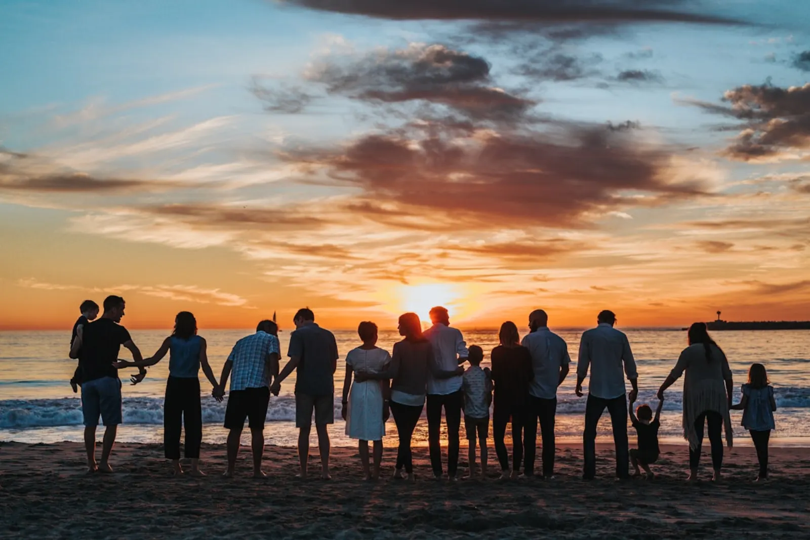 A multigenerational family together at sunset